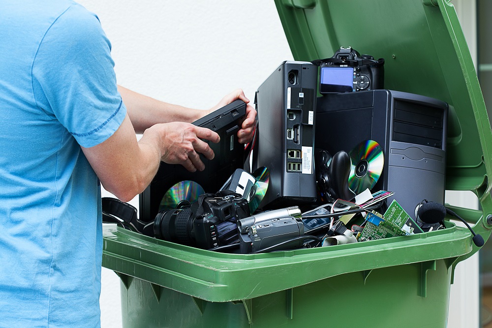 Man discarding old electronics